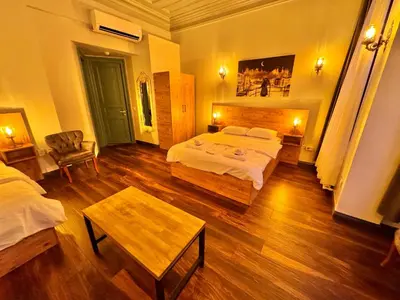 a bedroom with a bed and a table in it at Otel Kadıköy in Istanbul