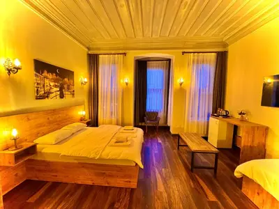 a bedroom with a large bed and a table at Otel Kadıköy in Istanbul