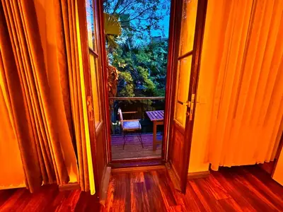 an open door leading to a balcony with a chair at Otel Kadıköy in Istanbul