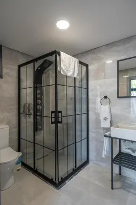 a bathroom with a shower with a toilet and a sink at Sapanca Kokina Suit in Sakarya
