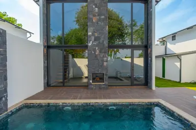 a house with a fireplace and a swimming pool at Sapanca Kokina Suit in Sakarya