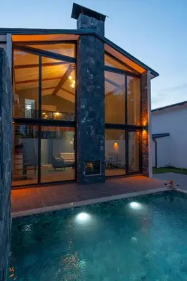 a glass house with a pool in front of it at Sapanca Kokina Suit in Sakarya