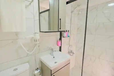 a white bathroom with a sink and a shower at Lucky Hotel İstanbul in Istanbul