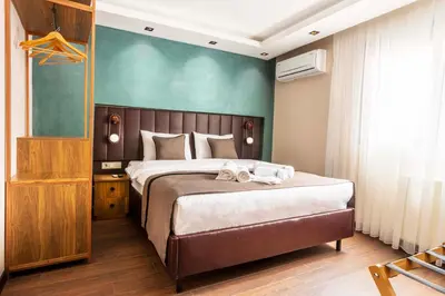 a bedroom with a large bed and a green wall at Marlon Hotel in Istanbul