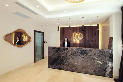 a woman standing in a lobby with a mirror at Pisa Hotel in Istanbul