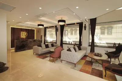 a living room with couches and a table and chairs at Pisa Hotel in Istanbul