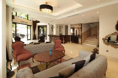 a living room with a couch and chairs and a table at Pisa Hotel in Istanbul