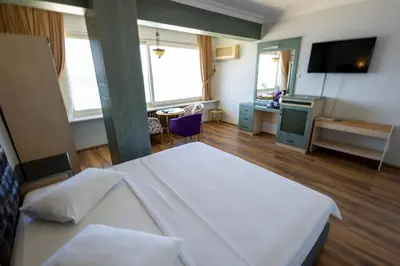 a hotel room with a bed and a television at Karamürsel Mohti Otel Fitness Organizasyon in Karamusal