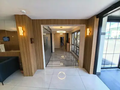 a hallway in a building with glass doors and a staircase at Karamürsel Mohti Otel Fitness Organizasyon in Karamusal