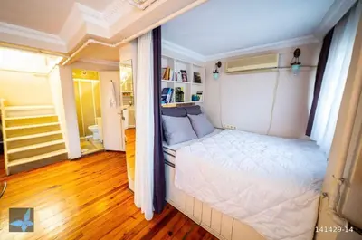 a bedroom with a white bed in a room at Taksim FunHouse in Istanbul