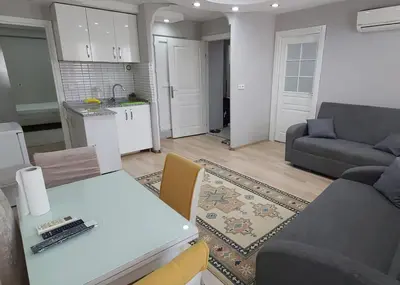 a kitchen and living room with a table and a couch at Hane Apart in Istanbul