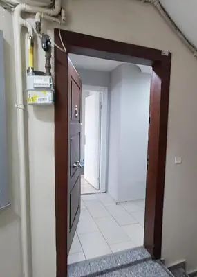 an open door to a hallway with a white tile floor at Hane Apart in Istanbul