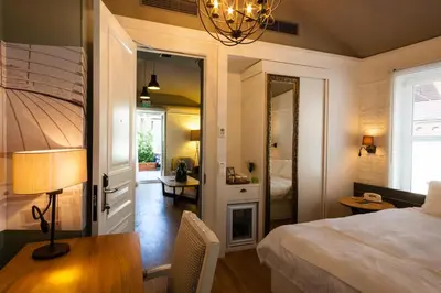 a bedroom with a bed and a desk and a mirror at Pino Verde Hotel in Istanbul