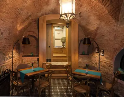 a restaurant with two tables and chairs and a hallway at Pino Verde Hotel in Istanbul