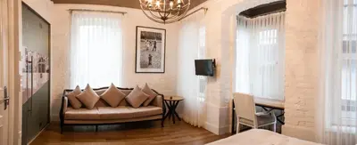 a living room with a couch and a chandelier at Pino Verde Hotel in Istanbul