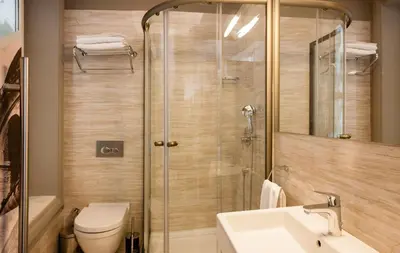 a bathroom with a shower and a toilet and a sink at Pino Verde Hotel in Istanbul