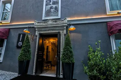 a building with two trees in front of a doorway at Pino Verde Hotel in Istanbul
