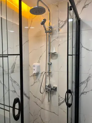 a shower in a bathroom with a glass door at The Blue Suites in Istanbul