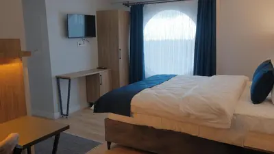 a bedroom with a bed and a window and a table at The Blue Suites in Istanbul