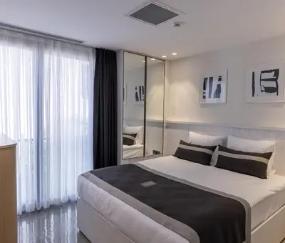 a bedroom with a large bed and a large window at The Public Ortakoy in Istanbul