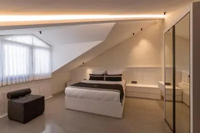 a bedroom with a large bed and a staircase at The Public Ortakoy in Istanbul