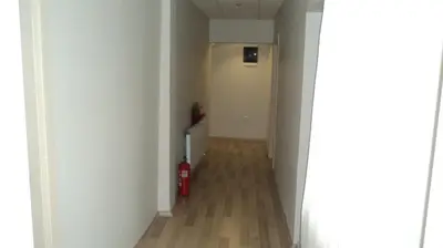 a hallway with a red fire extinguisher in a room at Kadikoy Bade 3 Hotel in Istanbul