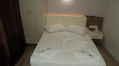 a white bed in a room with two towels on it at Kadikoy Bade 3 Hotel in Istanbul