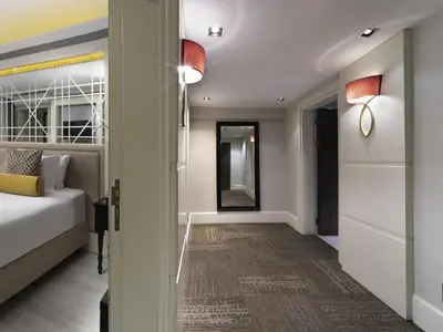 a bedroom with a bed and a hallway with a mirror at Mercure Istanbul Bomonti in Istanbul