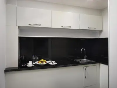 a kitchen with a bowl of fruit and a sink at Mercure Istanbul Bomonti in Istanbul