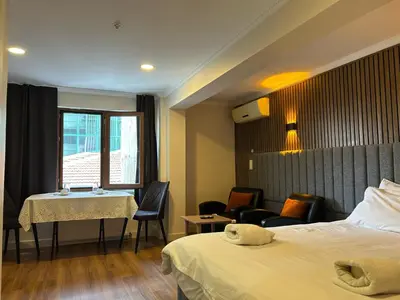 a hotel room with a bed and a table and chairs at Naila Hotel in Istanbul