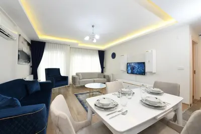 a living room with a white table and chairs at Kardeş Suite 5 in Istanbul
