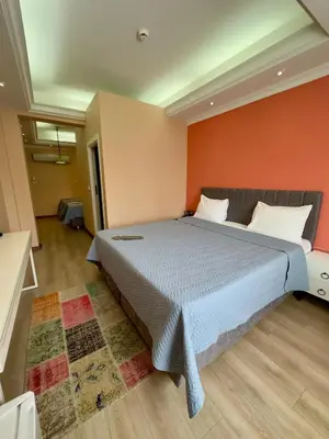 a bedroom with a large bed with an orange wall at Elite Marmara Express Otel in Istanbul