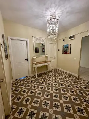 a hallway with a table and a chandelier at Elite Marmara Express Otel in Istanbul