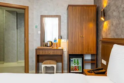 a bedroom with a bed and a desk and a sink at Diamond Beyazit Hotel in Istanbul