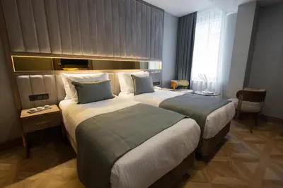 a hotel room with two beds and a window at Buke Hotel Bomonti in Istanbul