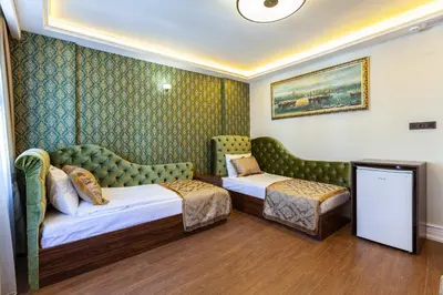 a hotel room with two beds and a couch at Rose Apartments in Istanbul