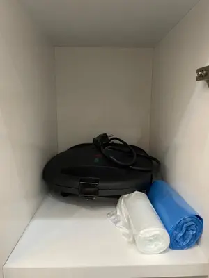 a black suitcase sitting on a shelf with a blue pillow at Stay in the heart of the city in Istanbul