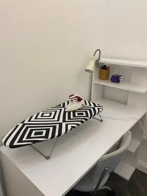 a white desk with a black and white blanket on it at Stay in the heart of the city in Istanbul