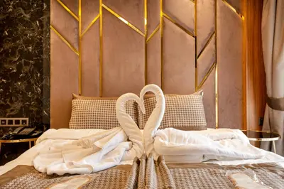 a bed with two white towels on it at Santra Hotel in Istanbul