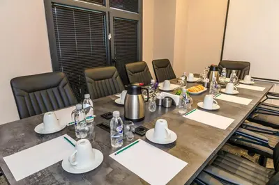 a conference room with a long table and chairs at Elysian Airport Hotel & Restaurant in Arnavutköy