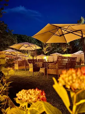 a group of tables with umbrellas and chairs at Aşiyan Yalısı in İznik