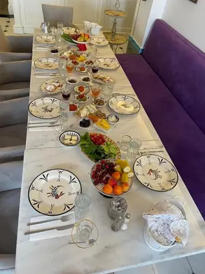 a long table filled with plates and bowls of food at Aşiyan Yalısı in İznik
