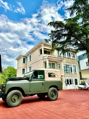 a green truck parked in front of a house at Aşiyan Yalısı in İznik