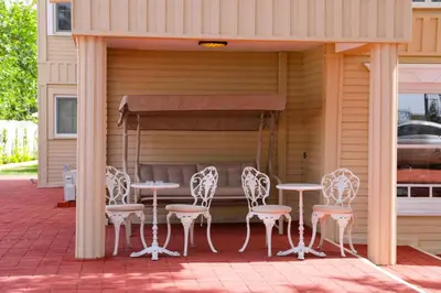 a patio with tables and chairs in a garage at Aşiyan Yalısı in İznik