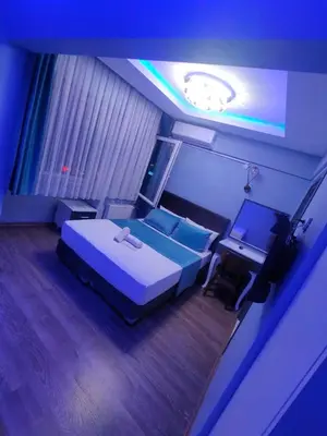 a bedroom with a large bed and a tv at Grand Bona Sera Hotel in Istanbul