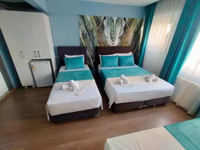 two beds in a room with blue and white at Grand Bona Sera Hotel in Istanbul