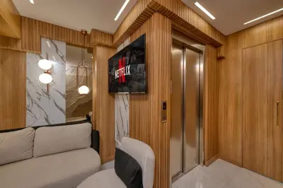 a room with a couch and a tv on a wall at Swans Hotel Old City Grand Bazar in Istanbul