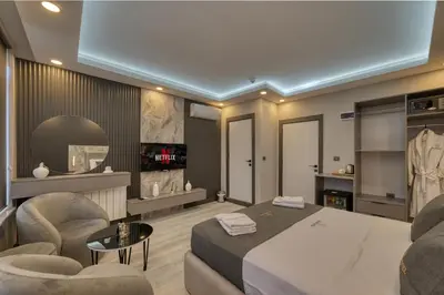 a bedroom with a bed and a living room at Swans Hotel Old City Grand Bazar in Istanbul