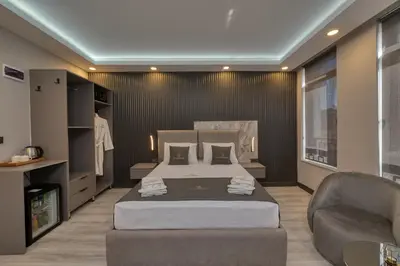 a bedroom with a bed and a couch and a chair at Swans Hotel Old City Grand Bazar in Istanbul
