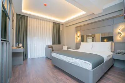a hotel room with a large bed and a chair at 216 Style Suite in Istanbul
